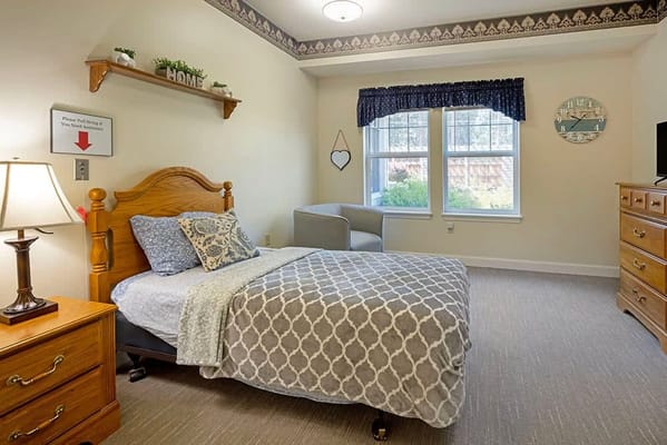 Cozy resident room with bed and armchair