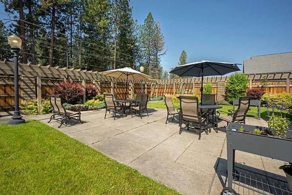 Outdoor seating area with umbrellas and landscaping