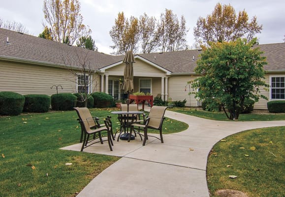 Outdoor seating area with a pathway and trees