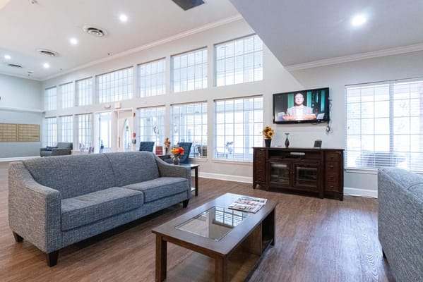 Bright common area with sofas and a television