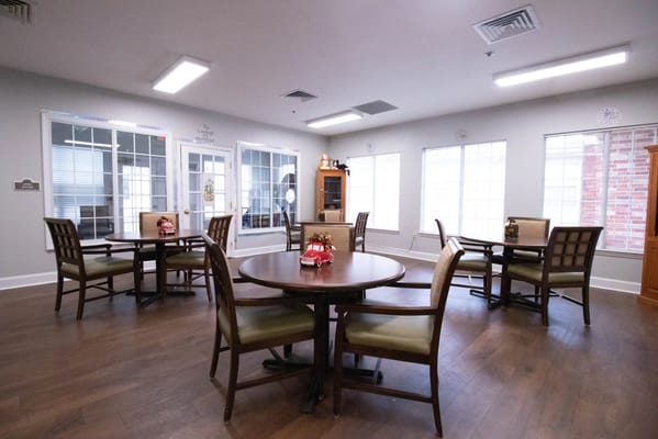 Bright activity room with tables and chairs