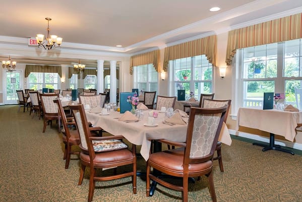 Dining area with elegantly set tables and chairs