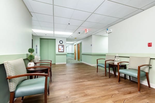 Well-lit corridor with seating area in a senior facility