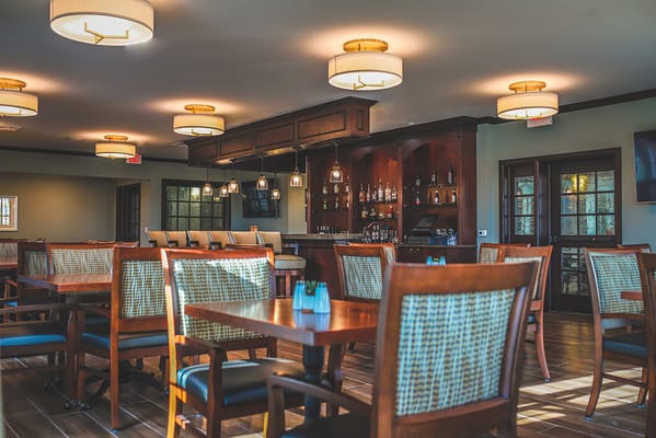 Bright dining area with wooden tables and chairs