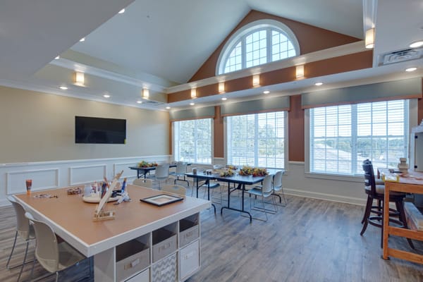 Bright interior room with large windows and seating areas