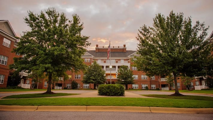Exterior view of a senior living facility with trees