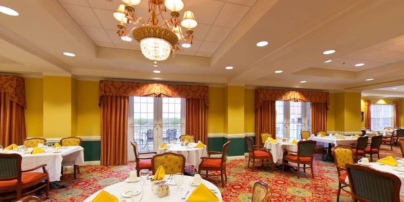 Bright dining room with tables set for meals