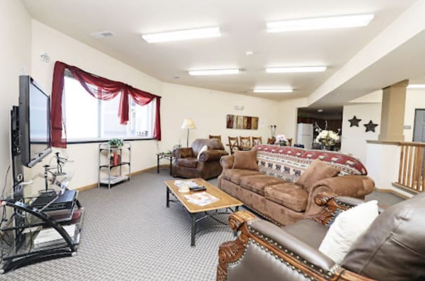 Cozy living room with brown sofas and a television