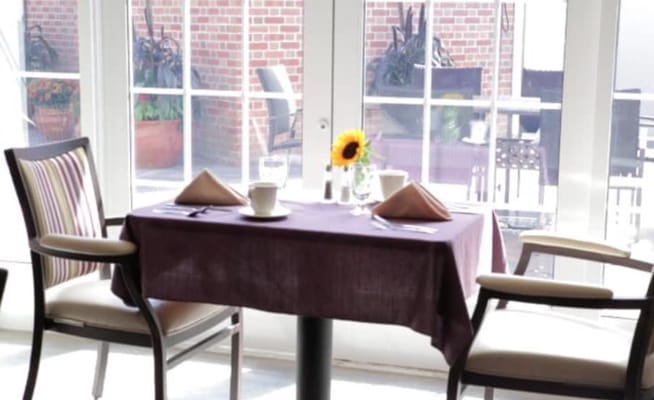 Dining table set with flowers and tableware