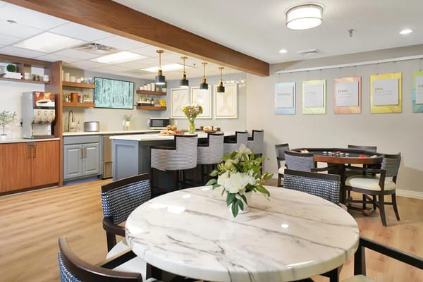 Bright dining area with marble table and food options