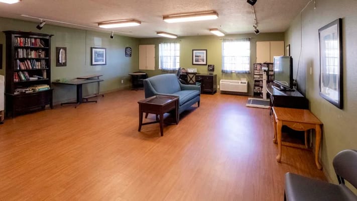 Bright common area with seating and bookshelves