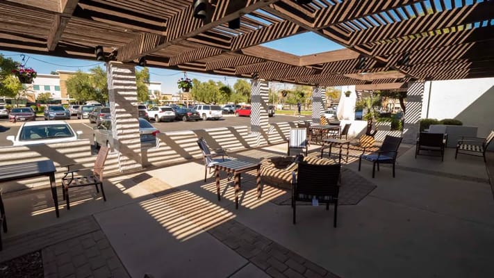 Shaded outdoor seating area with tables and chairs