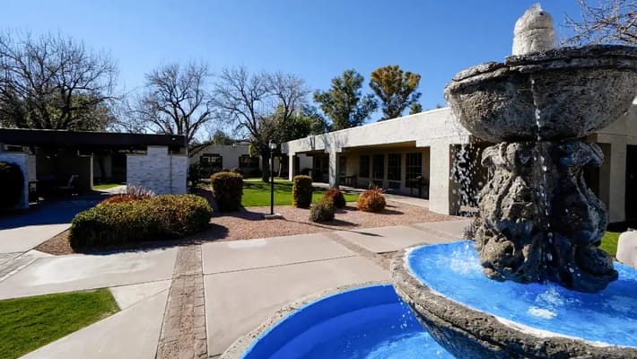 View of a courtyard with a fountain and seating areas
