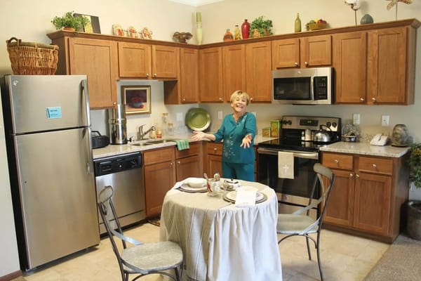 A cheerful resident in a kitchen setting