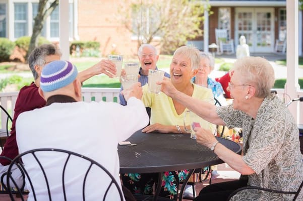 Residents enjoying a cheerful outdoor gathering with drinks