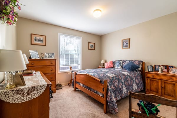 Cozy resident room with a bed and wooden furniture