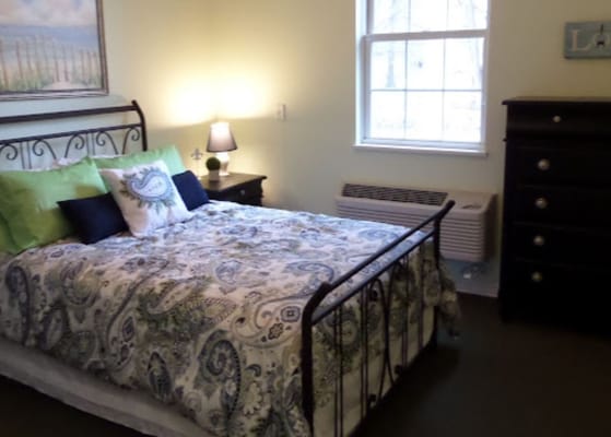 Cozy bedroom with a decorative bed and drawer