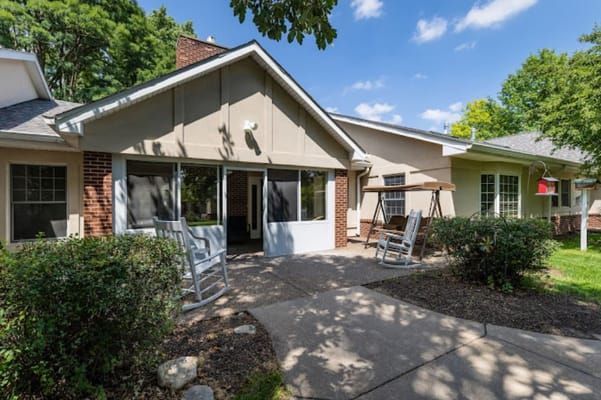 Exterior view of a patio area with rocking chairs