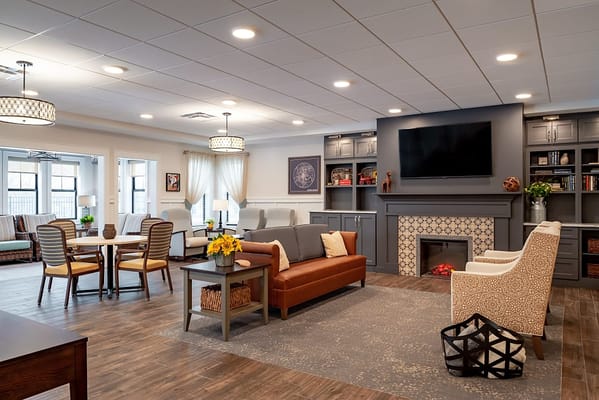 Bright and inviting common area with seating and a fireplace