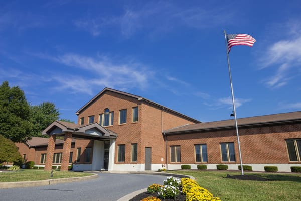 Building exterior of Courtland Manor with American flag