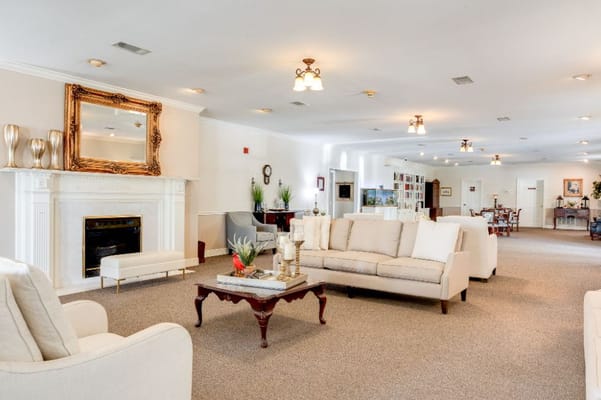 Bright common area with comfortable seating and a fireplace