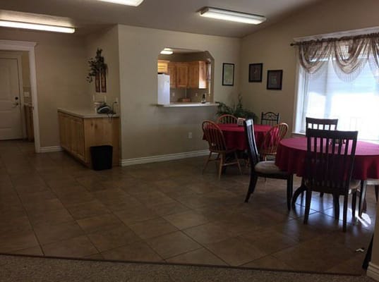 Bright common area with dining tables and chairs