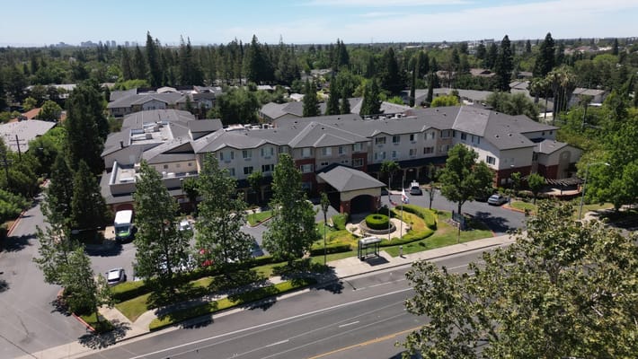 Aerial view of a senior living facility surrounded by greenery