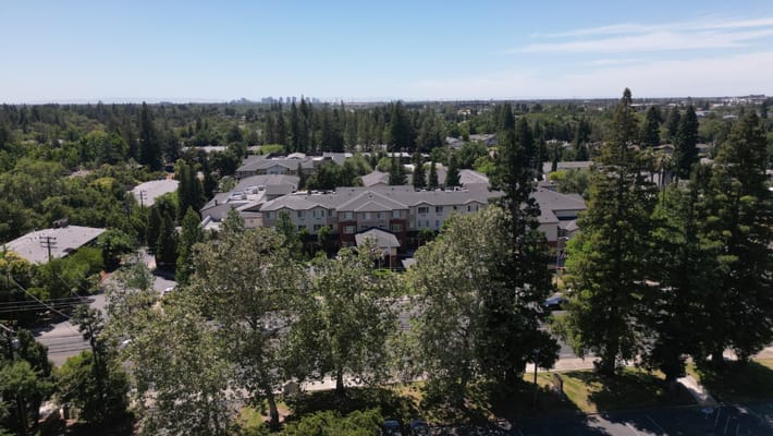 Aerial view of a senior living facility surrounded by trees