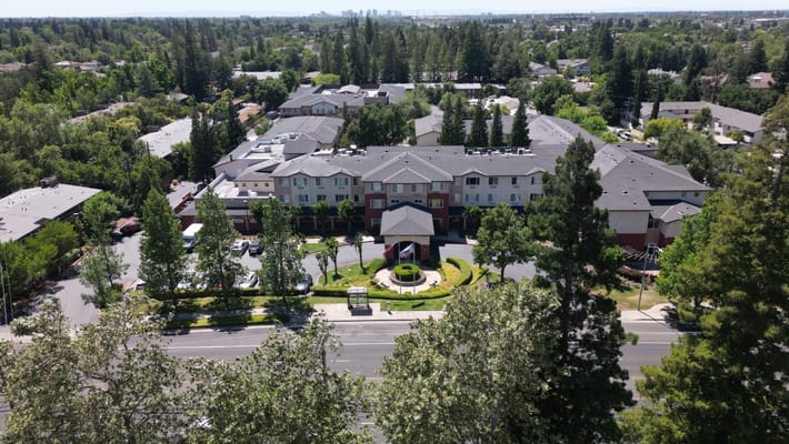 Aerial view of a senior living facility surrounded by greenery