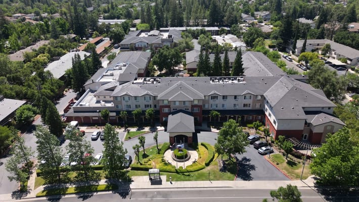 Aerial view of a senior living facility with landscaped grounds