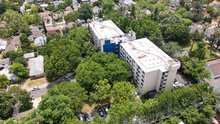 Aerial view of a senior living facility surrounded by trees