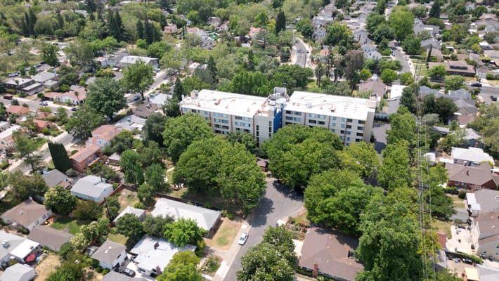 Aerial view of a senior living facility surrounded by greenery