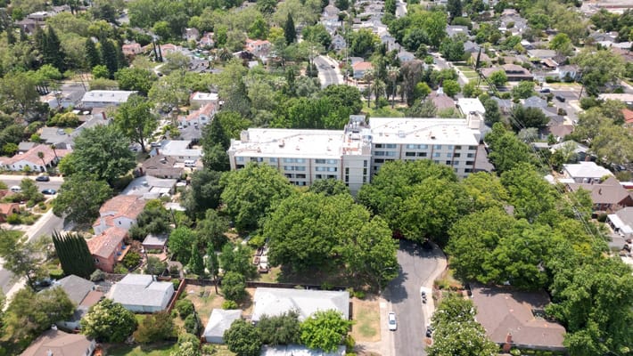 Aerial view of a senior living facility surrounded by greenery