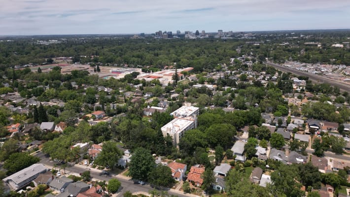 Aerial view of a senior living campus surrounded by trees