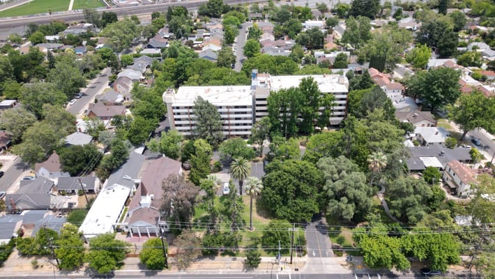 Aerial view of a senior living facility surrounded by greenery