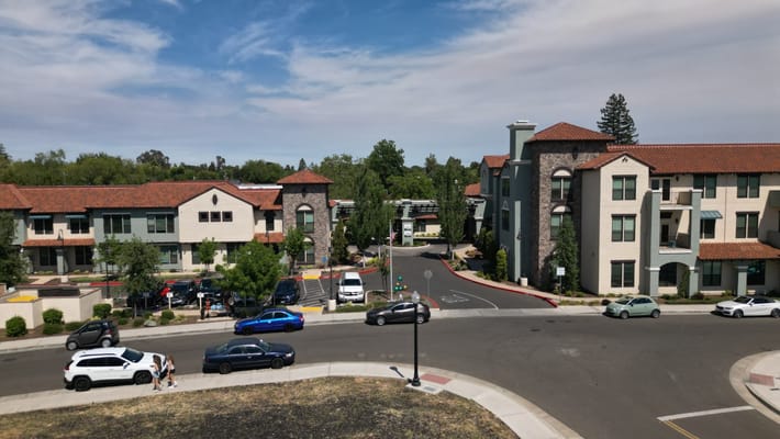 Exterior view of Oakmont of East Sacramento with residents and vehicles
