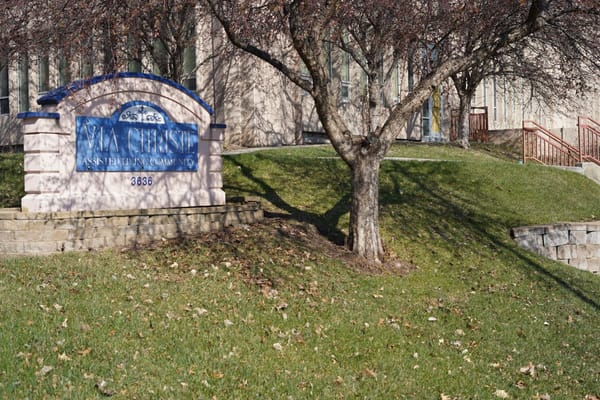 Facility logo sign outside with landscaping