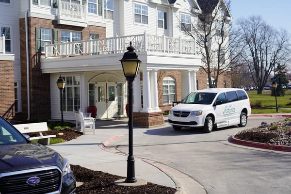 Exterior view of assisted living facility with transport van