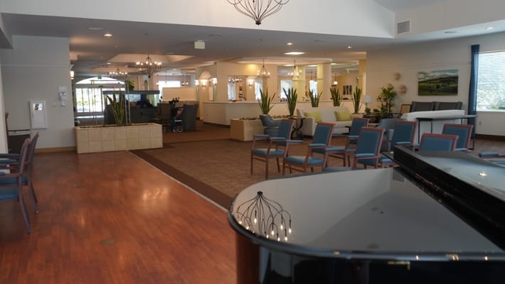 Bright common area with seating and piano