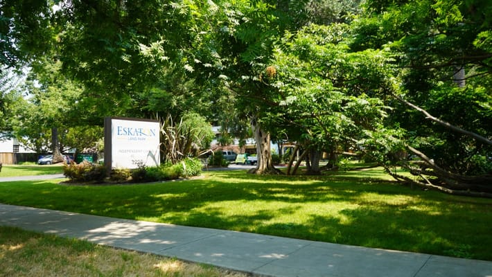 Exterior view of Eskaton Land Park sign among trees