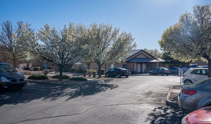 Exterior view of the facility with flowering trees