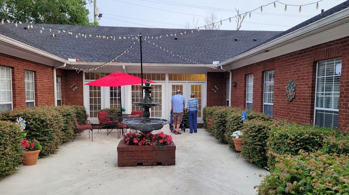 Residents enjoying the outdoor courtyard with a fountain