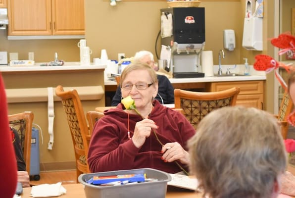 Resident enjoying a craft activity in a common area