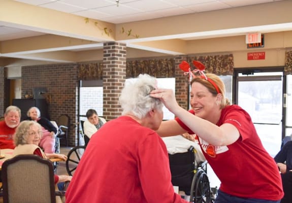 Staff member celebrating with a resident in a common area
