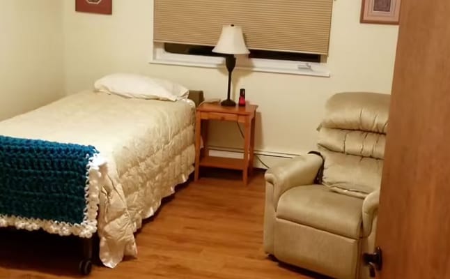 Private resident room with a bed and chair