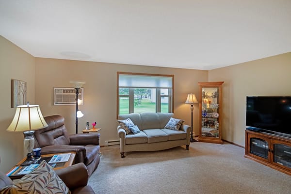 Cozy living room with seating and TV at Derian Lodge Senior Living