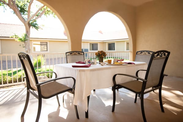 Outdoor dining area with a table set for a meal