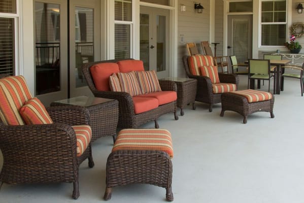 Cozy outdoor seating area with wicker chairs and colorful cushions