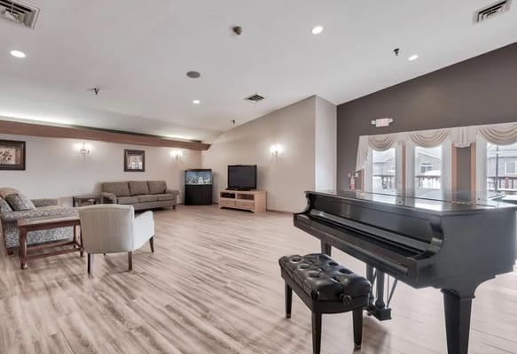 Bright common area with a piano and seating