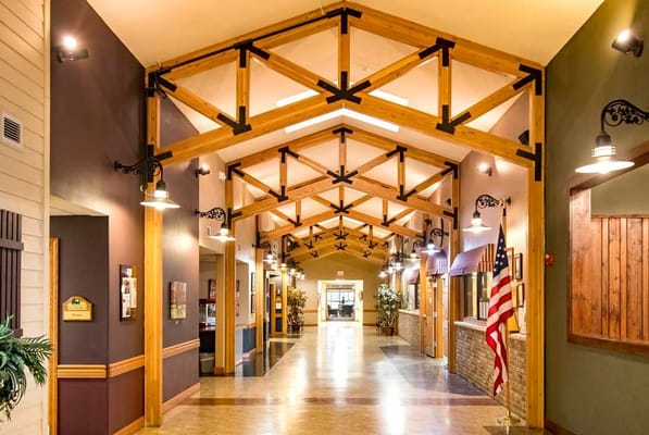 Interior hallway of a senior living facility with wooden beams